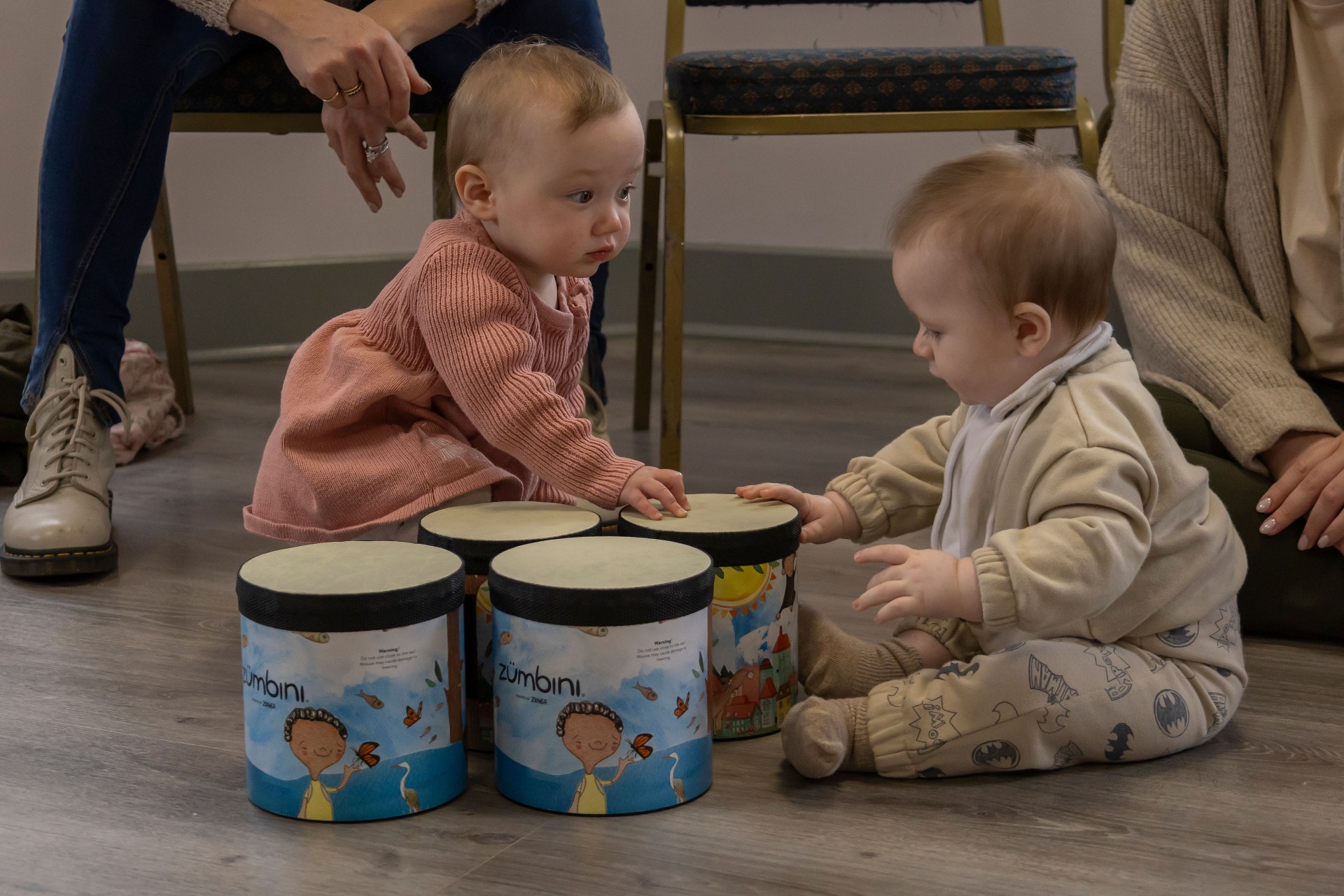 Two babies playing on Zumbini drums